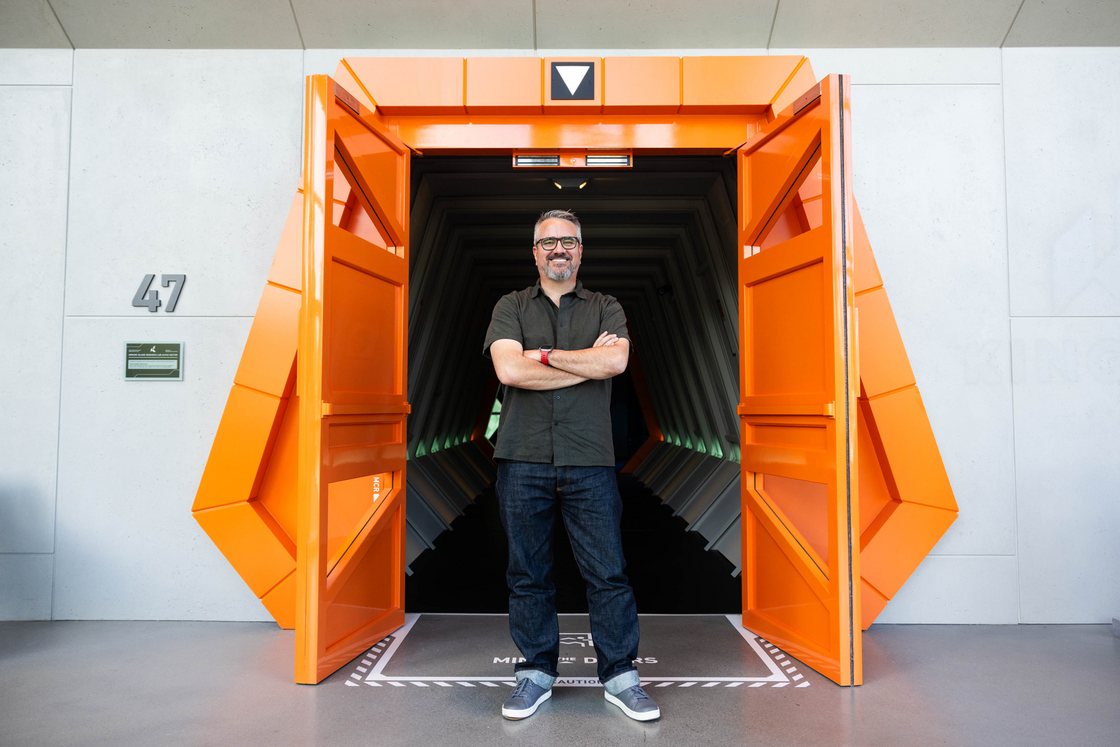 Deke stands in front of the entrance to the new VALORANT-themed Seattle office